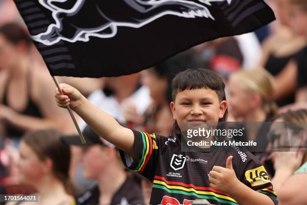 Young Panthers fan watches a Penrith Panthers NRL training session at BlueBet Stadium on September 26, 2023 in Penrith, Australia.