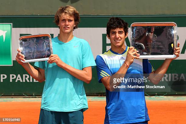 Runner up Alexander Zverev of Germany and winner Christian Garin of Chile posewith their trophies after the boys' singles final matchduring day...