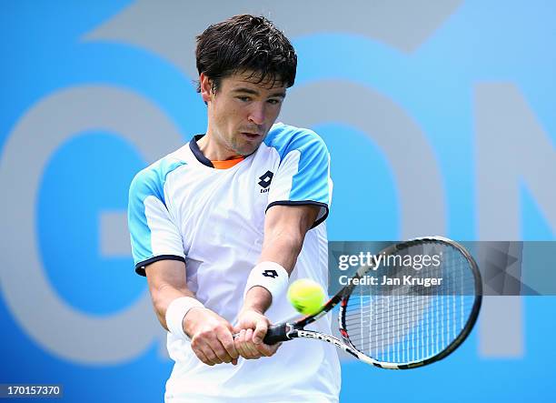 Jamie Baker of Great Britain in action against Prakash Amritraj of India during the a qualifying round ahead of the AEGON Championships at Queens...