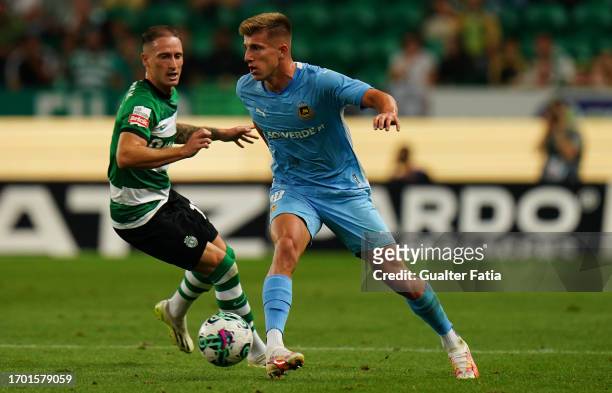 Costinha of Rio Ave FC with Nuno Santos of Sporting CP in action during the Liga Portugal Betclic match between Sporting CP and Rio Ave FC at Estadio...