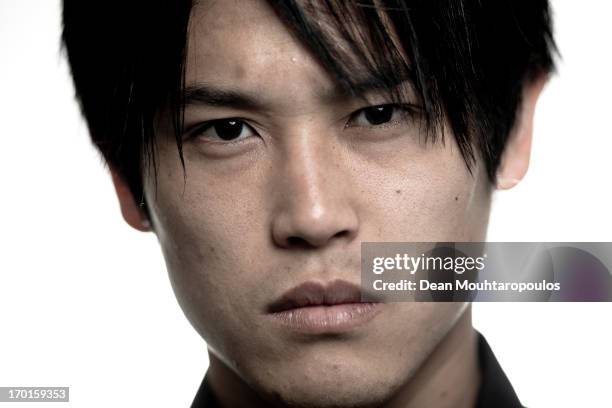 Atsuto Uchida of Japan and club football team Schalke 04 poses during a portrait session at Veltins-Arena on April 25, 2013 in Gelsenkirchen, Germany.