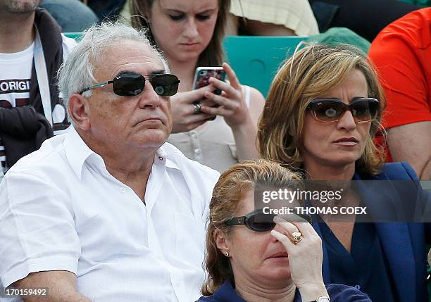 Former IMF chief Dominique Strauss-Kahn and his partner, Media Marketing Executive Myriam L'Aouffir attend the women's French tennis Open final match...