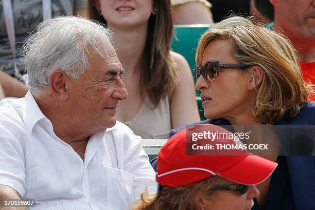 Former IMF chief Dominique Strauss-Kahn and his partner, Media Marketing Executive Myriam L'Aouffir attend the women's French tennis Open final match...