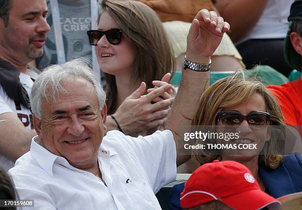 Former IMF chief Dominique Strauss-Kahn and his partner, Media Marketing Executive Myriam L'Aouffir attend the women's French tennis Open final match...