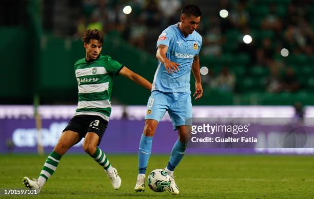 Leonardo Ruiz of Rio Ave FC with Daniel Braganca of Sporting CP in action during the Liga Portugal Betclic match between Sporting CP and Rio Ave FC...