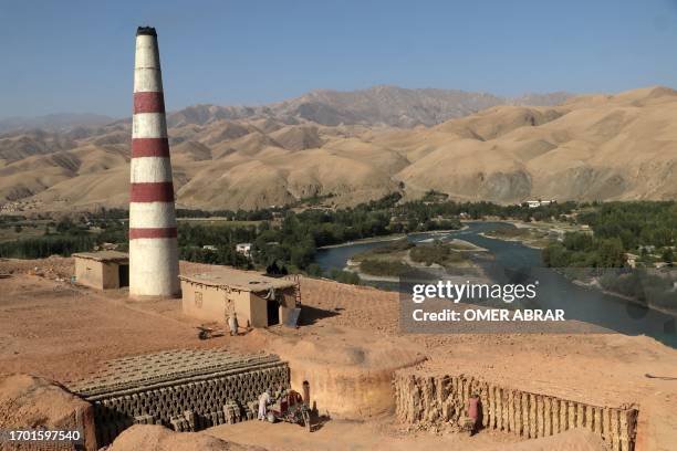 Labourers work at a brick kiln in Fayzabad district of Badakhshan province on October 2, 2023.