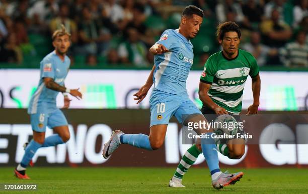 Amine Oudrhiri of Rio Ave FC with Hidemasa Morita of Sporting CP in action during the Liga Portugal Betclic match between Sporting CP and Rio Ave FC...