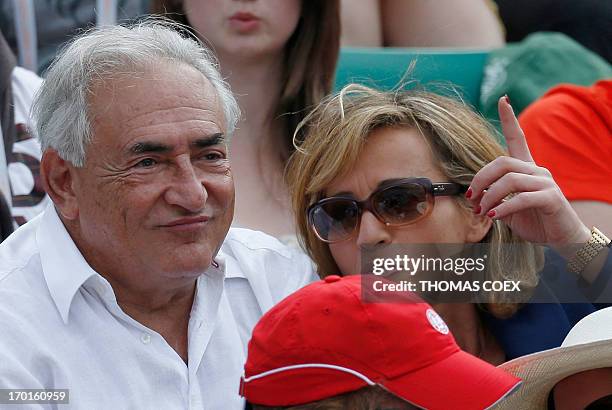 Former IMF chief Dominique Strauss-Kahn and his partner, Media Marketing Executive Myriam L'Aouffir attend the women's French tennis Open final match...