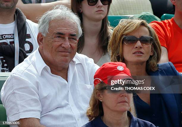 Former IMF chief Dominique Strauss-Kahn and his partner, Media Marketing Executive Myriam L'Aouffir attend the women's French tennis Open final match...