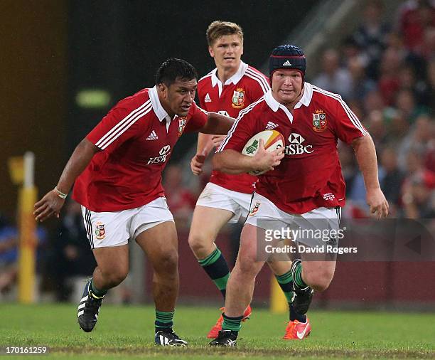 Matt Stevens of the Lions charges upfield with Mako Vunipola in support during the match between the Queensland Reds and the British & Irish Lions at...