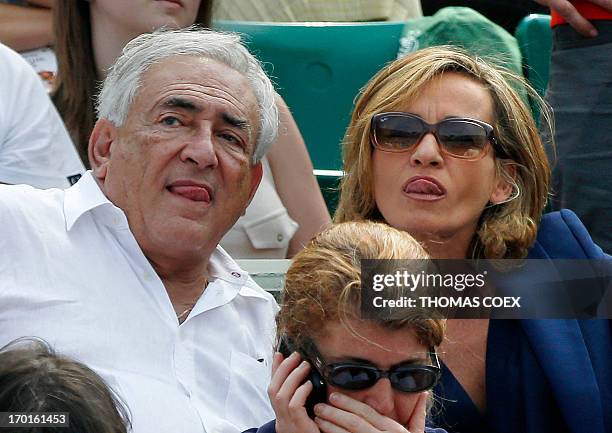 Former IMF chief Dominique Strauss-Kahn and his partner, Media Marketing Executive Myriam L'Aouffir attend the women's French tennis Open final match...