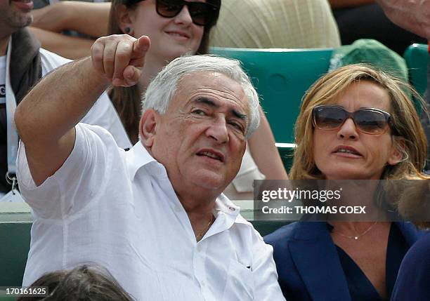Former IMF chief Dominique Strauss-Kahn and his partner, Media Marketing Executive Myriam L'Aouffir attend the women's French tennis Open final match...