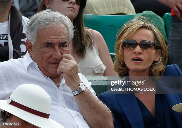 Former IMF chief Dominique Strauss-Kahn and his partner, Media Marketing Executive Myriam L'Aouffir attend the women's French tennis Open final match...