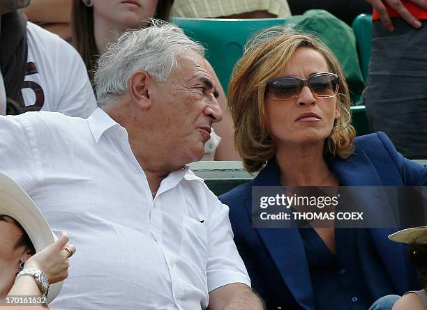 Former IMF chief Dominique Strauss-Kahn and his partner, Media Marketing Executive Myriam L'Aouffir attend the women's French tennis Open final match...