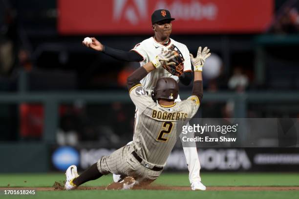 Marco Luciano of the San Francisco Giants turns a double play as Xander Bogaerts of the San Diego Padres is forced out at second base in the eighth...