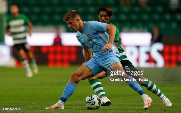 Costinha of Rio Ave FC with Hidemasa Morita of Sporting CP in action during the Liga Portugal Betclic match between Sporting CP and Rio Ave FC at...