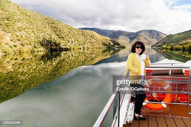 woman drinking coffee on a river cruise - europe river cruise stock pictures, royalty-free photos & images