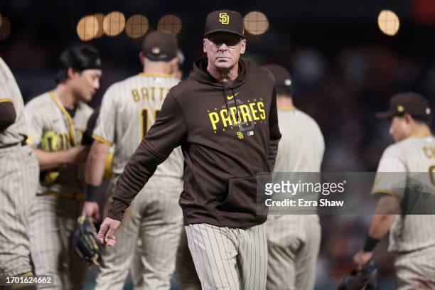 San Diego Padres manager Bob Melvin walks back to the dugout after making a pitching change in the seventh inning of their game against the San...