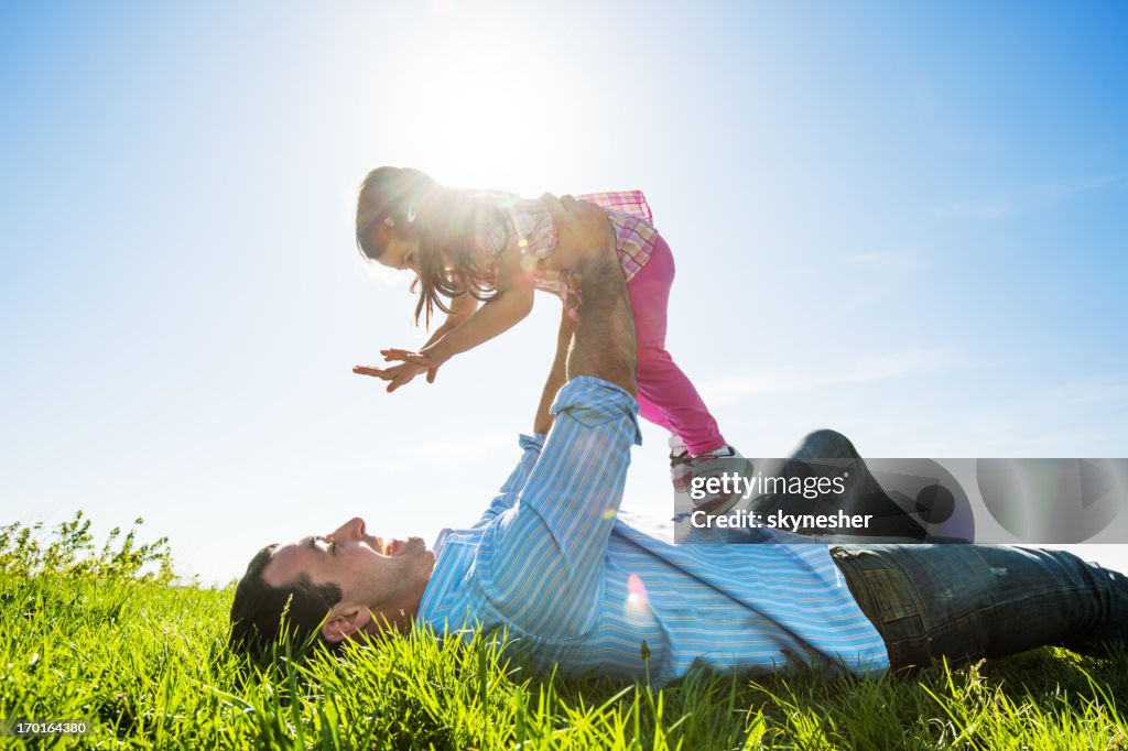Father with her daughter in park.
