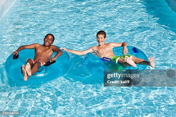 preteen friends on innertubes at water park - trögflytande bildbanksfoton och bilder