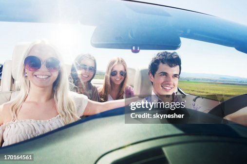 Convertible Car Ride Group Of Young People Enjoying In A Convertible Car Ride High-Res Stock ...