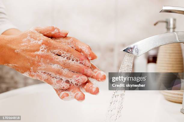 unrecognizable person washing hands. - soap sud stock pictures, royalty-free photos & images