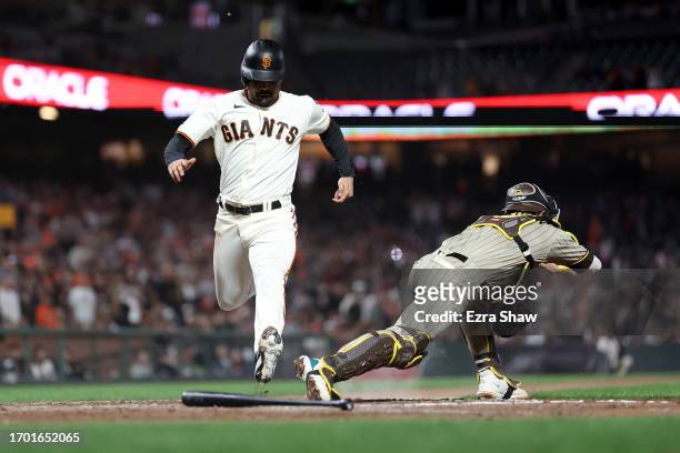 LaMonte Wade Jr. #31 of the San Francisco Giants is forced out as Brett Sullivan of the San Diego Padres covers home plate in the eighth inning at...