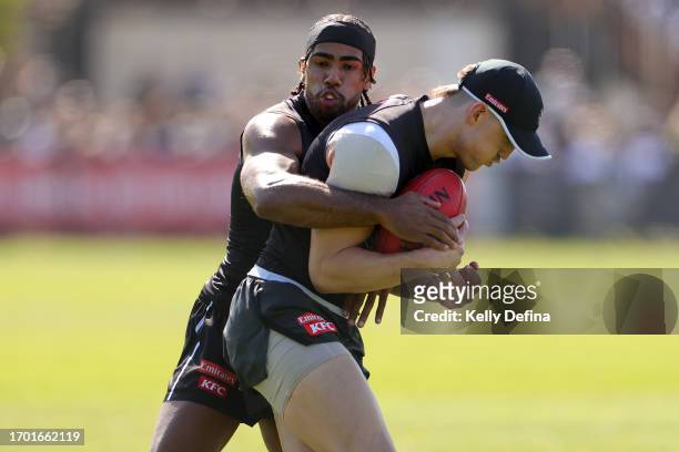 Isaac Quaynor of the Magpies tackles Brayden Maynard of the Magpies during a Collingwood Magpies AFL training session at AIA Centre on September 26,...