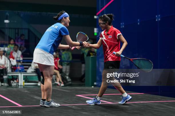 Sugimoto Risa of Japan greets Ngamprasert Supakorn of Thailand after their Squash Women's Team Pool A match during day three of the 19th Asian Games...