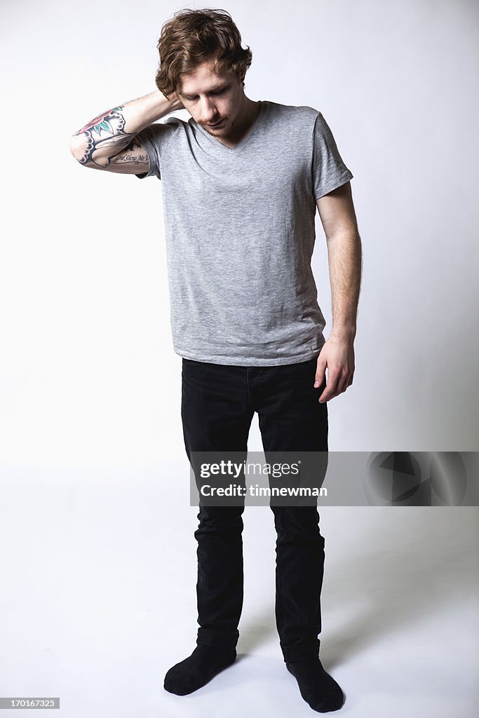 Young Attractive Caucasian Tattoo Hipster Man on White Background