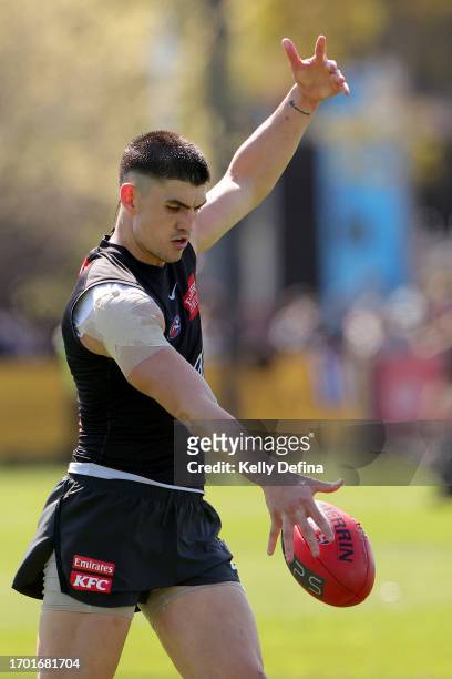 Brayden Maynard of the Magpies kicks the ball during a Collingwood Magpies AFL training session at AIA Centre on September 26, 2023 in Melbourne,...