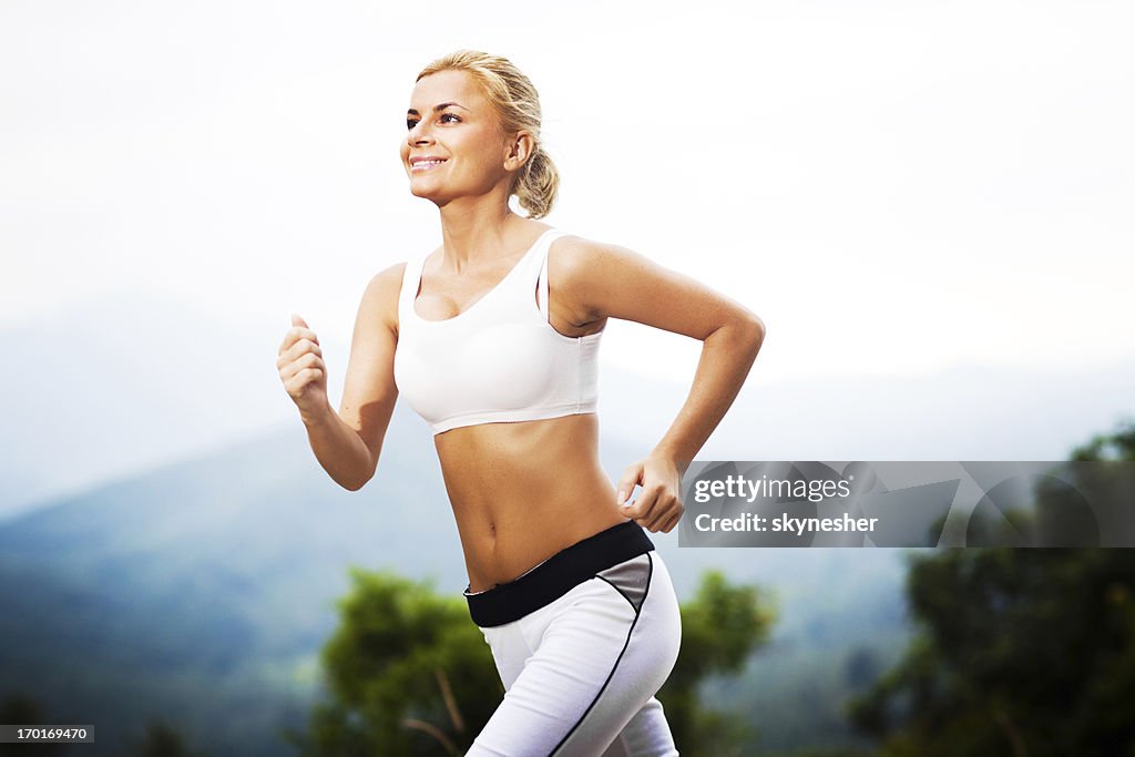 Young sporty woman running.