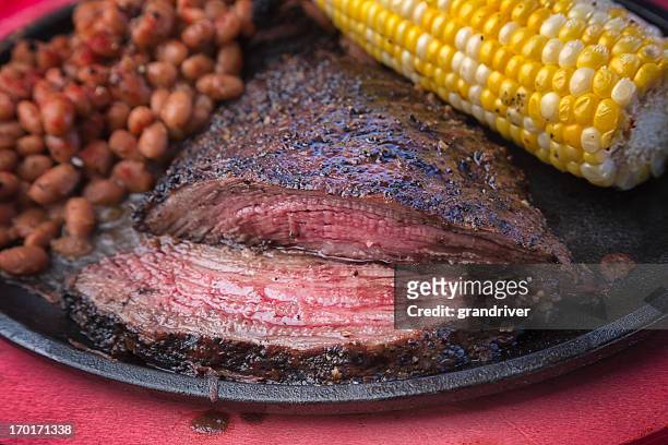 flank steak on a sizzling plate - beefsteak 2013 stock pictures, royalty-free photos & images