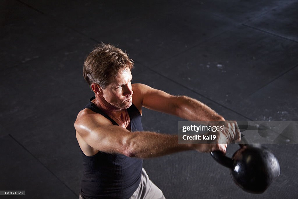 Man working out with kettle bell