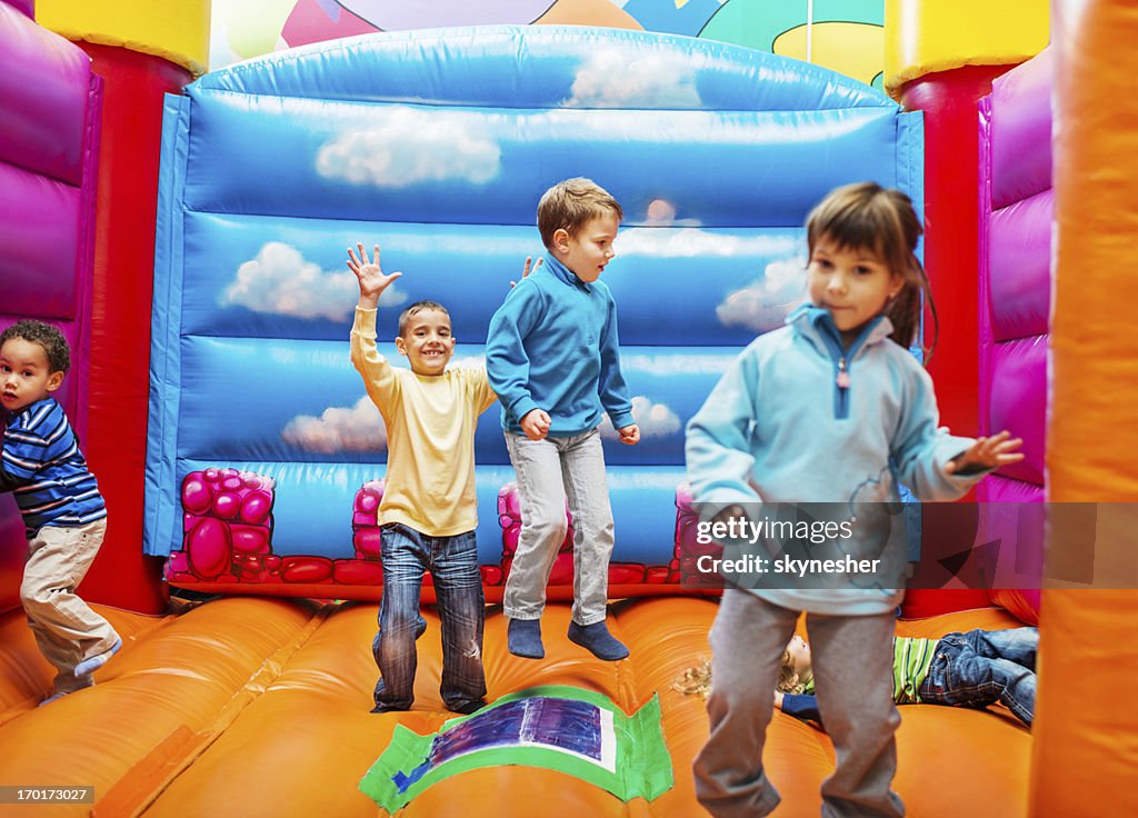 Kids enjoying in bouncy castle.