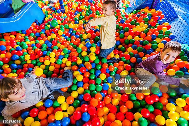cute little boys playing in the ball pool. - ball pit stock pictures, royalty-free photos & images