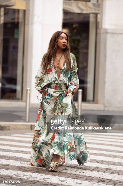 Karen Blanchard wears long silk jungle motives pattern V neck dress from Roberto Cavali, animal print platform heels and sunglasses outside Roberto...