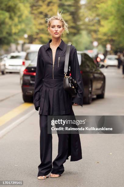 Emili Sindlev wears black pants, black miniskirt, black top with a zipper and a black bag outside Fendi during the Milan Fashion Week - Womenswear...