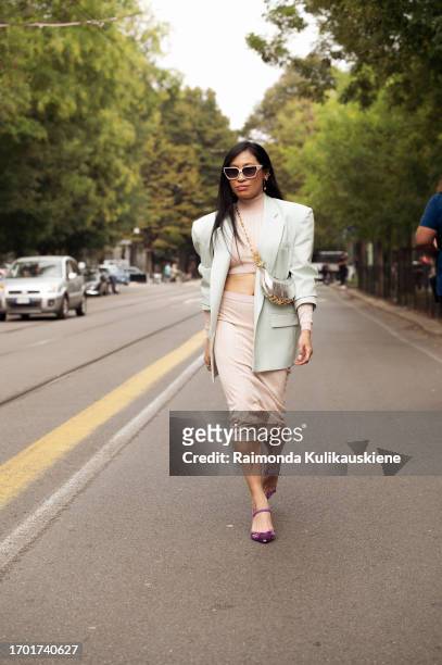 Miki Cheung wears beige pencil skirt, beige cropped top, mint green oversized blazer , purple pointy shoes and silver Fendi bag outside Fendi during...