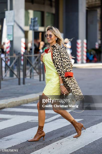 Ekaterina Mamaeva wears yellow dress Rasario, leopard print trench coat Max & Co, brown ankle boots Manu Atelier, white bag Celine, earrings Chanel...