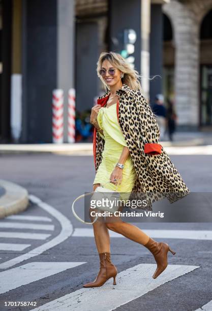 Ekaterina Mamaeva wears yellow dress Rasario, leopard print trench coat Max & Co, brown ankle boots Manu Atelier, white bag Celine, earrings Chanel...