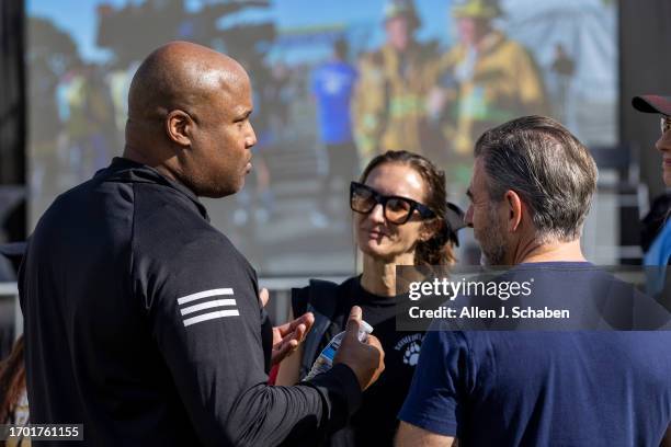 Los Angeles, CA Donald Brown Jr., left, father of Donald "Trey" Brown III, talks to classmates, family and friends of Jordan Park, Jonah Anschell and...