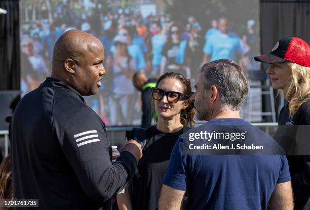 Los Angeles, CA Donald Brown Jr., left, father of Donald "Trey" Brown III, talks to classmates, family and friends of Jordan Park, Jonah Anschell and...