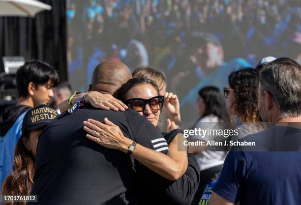 Los Angeles, CA Donald Brown Jr., left, father of Donald "Trey" Brown III, is hugged by classmates, family and friends of Jordan Park, Jonah Anschell...