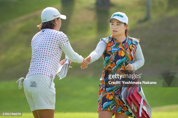 Rie Iwahashi and Hiroko Azuma of Japan shake hands after holing out on the 9th green during the first round of Sky Ladies ABC Cup at ABC Golf Club on...
