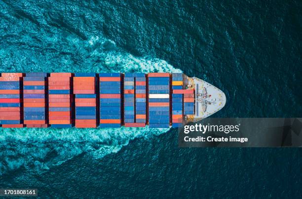 aerial top view container cargo ship full speed with beautiful wave pattern carrier container on the sea for business logistics, import export, shipping or freight transportation. - full elevator stock pictures, royalty-free photos & images