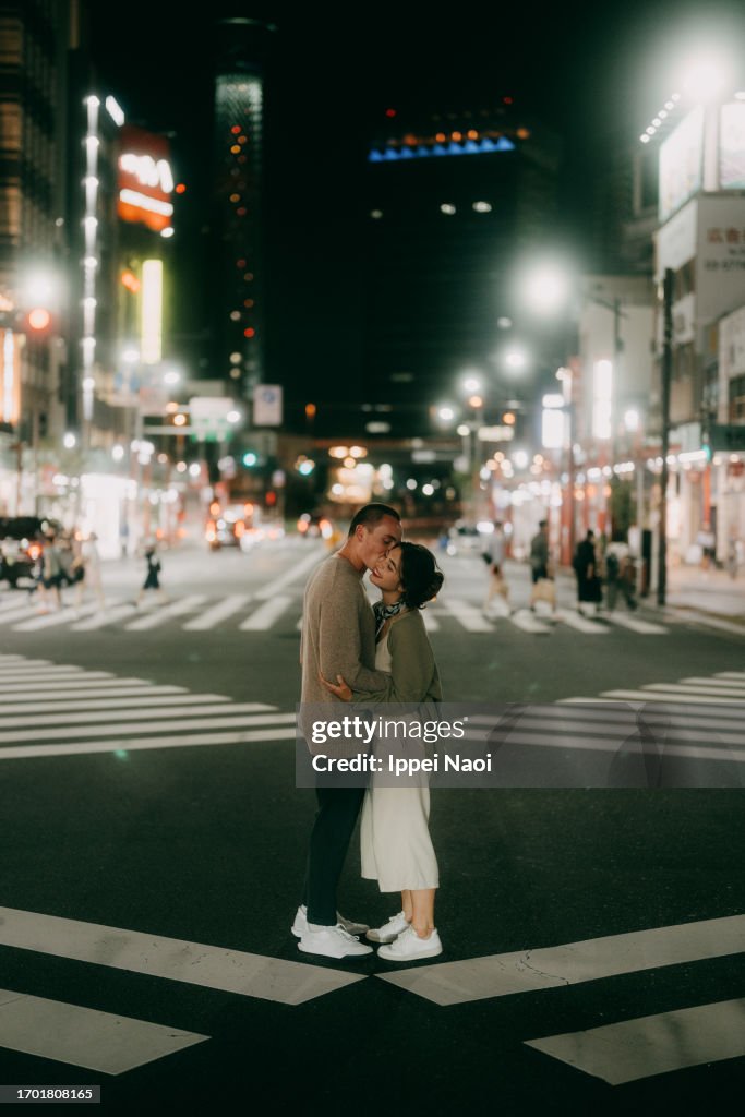 Couple having a romantic moment in Tokyo at night