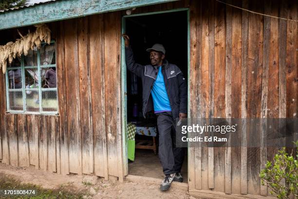 Porter Johana Macharia stands in his home after coming from the mountain in Gitinga Village, where 60% of the men work as mountain porters accounting...