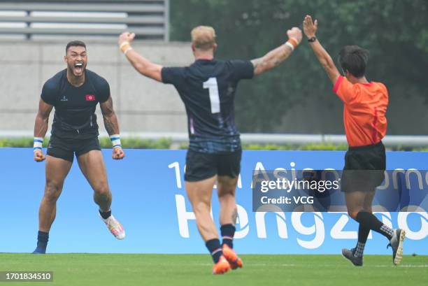 Players of Team Hong Kong celebrate against Team Japan in the Rugby Sevens - Men's Semifinal on day three of the 19th Asian Games at Hangzhou Normal...