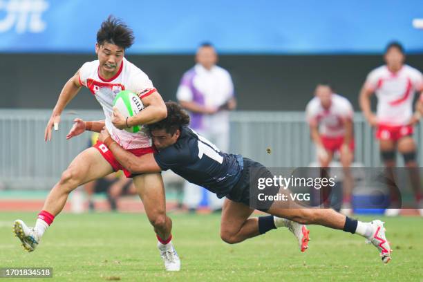 Team Japan competes against Team Hong Kong in the Rugby Sevens - Men's Semifinal on day three of the 19th Asian Games at Hangzhou Normal University...
